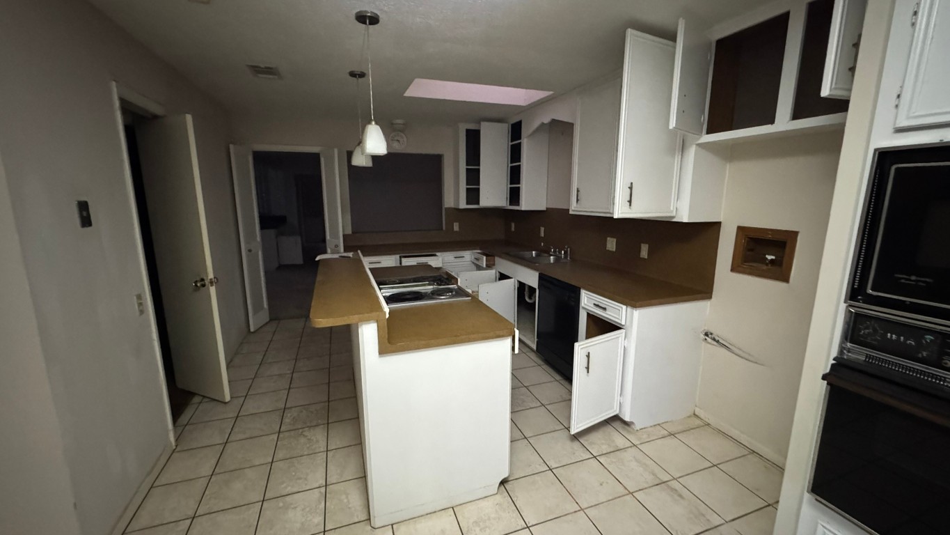 2162 Paso Rello Drive Houston, TX 77077 - Photo 10 of 32 a kitchen with a sink a refrigerator and cabinets