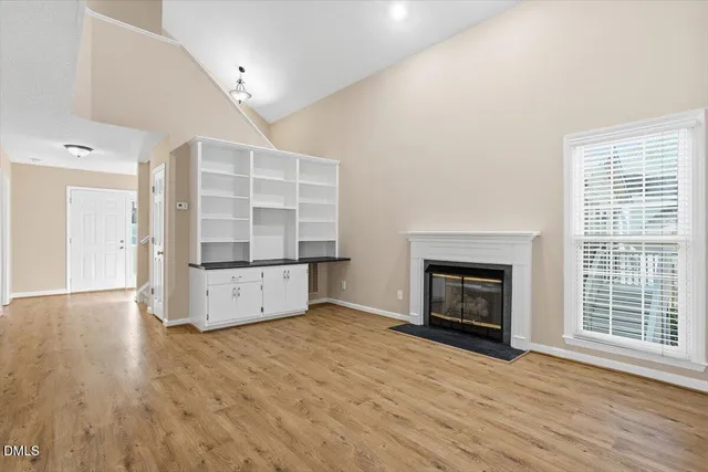 a view of an empty room with sliding glass door and mountain view