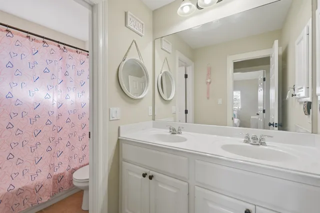 a bedroom with a bed dresser and a window