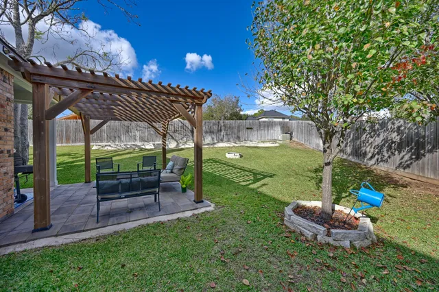 a living room with furniture a flat screen tv and a ceiling fan