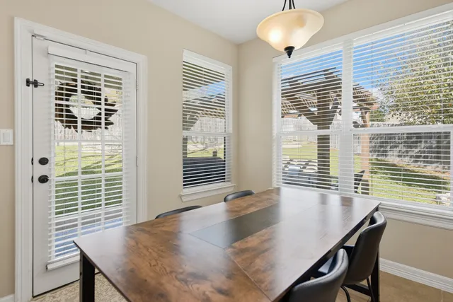 a kitchen with granite countertop wooden cabinets stainless steel appliances and a wooden floor