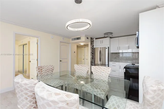 a kitchen with kitchen island granite countertop a refrigerator and a stove