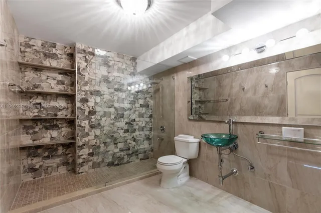 a bathroom with a toilet sink and shower