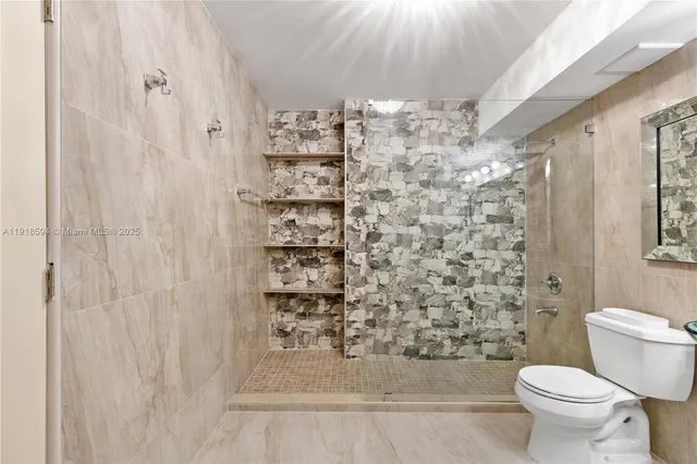 a bathroom with a toilet and shower