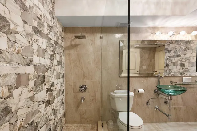 a bathroom with a toilet and shower