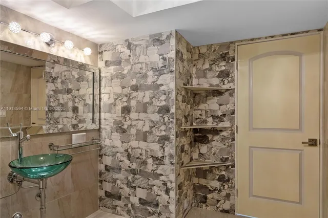 a bathroom with a shower and a sink