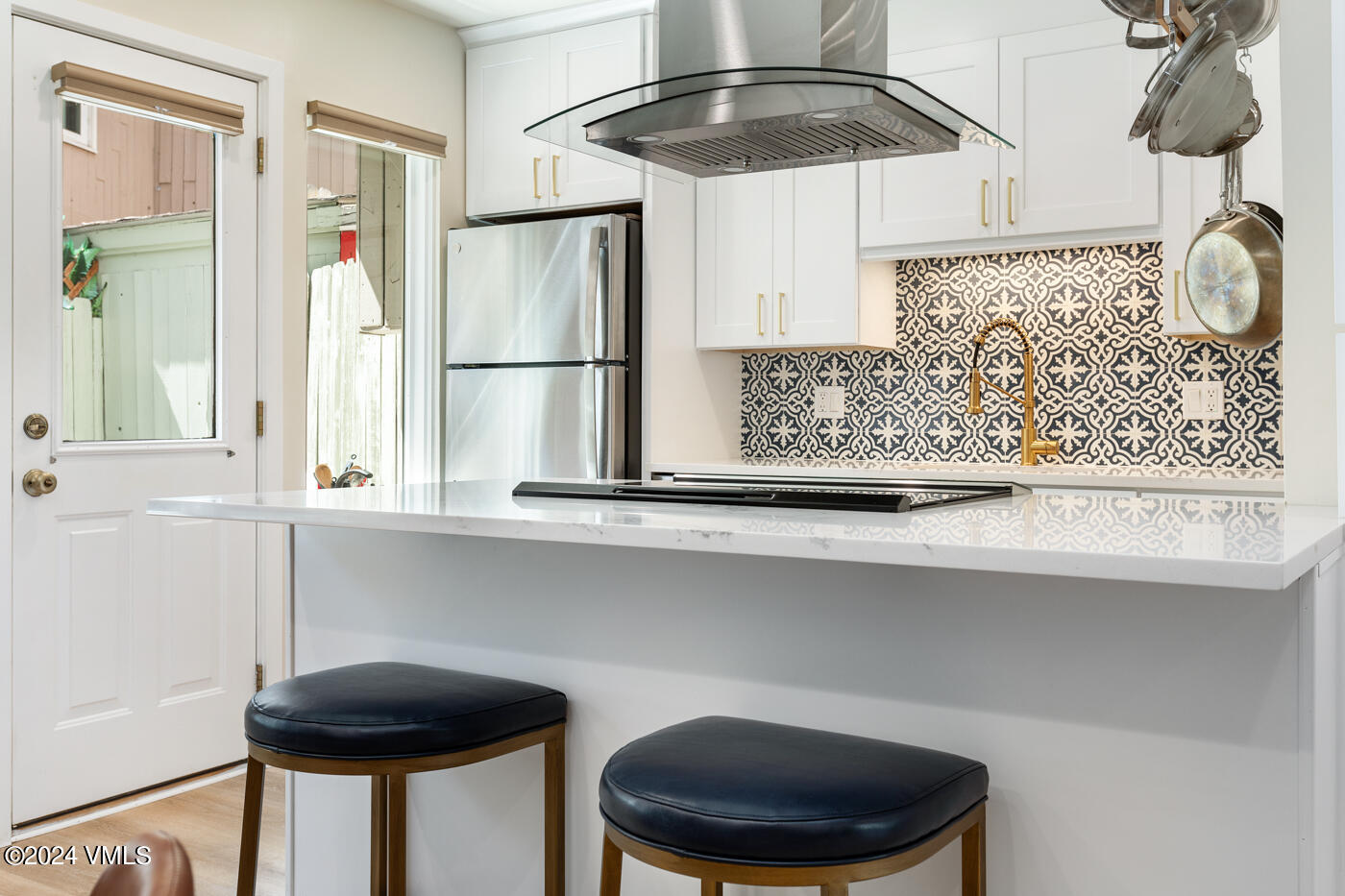 2199 Chamonix Lane, Unit 9 Vail, CO 81657 - Photo 11 of 24 a kitchen with a table and chandelier