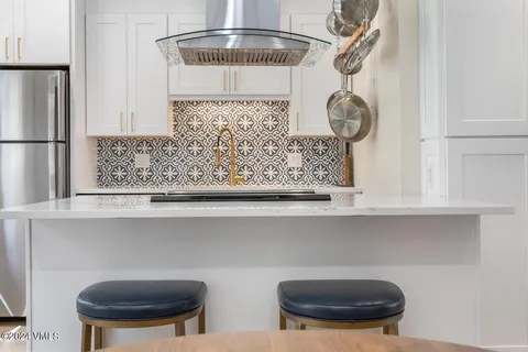 a kitchen with a sink a stove and cabinets