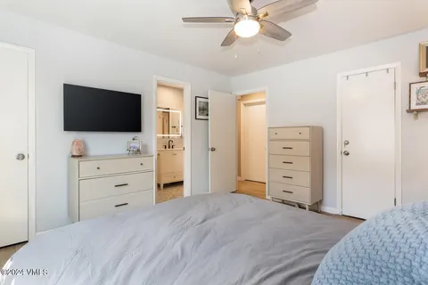 a bedroom with two beds and a large window