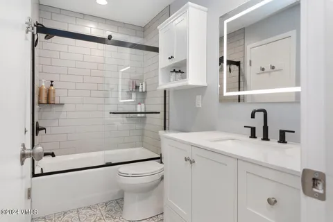 a bedroom with two beds and painting on the wall