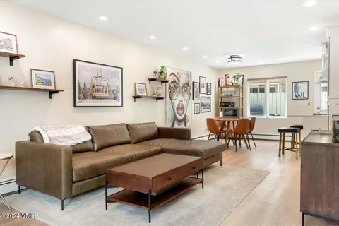 a living room with furniture and a mirror