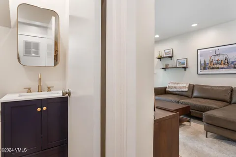 a bathroom with a toilet sink and mirror