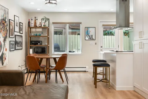a view of a dining room with furniture and wooden floor
