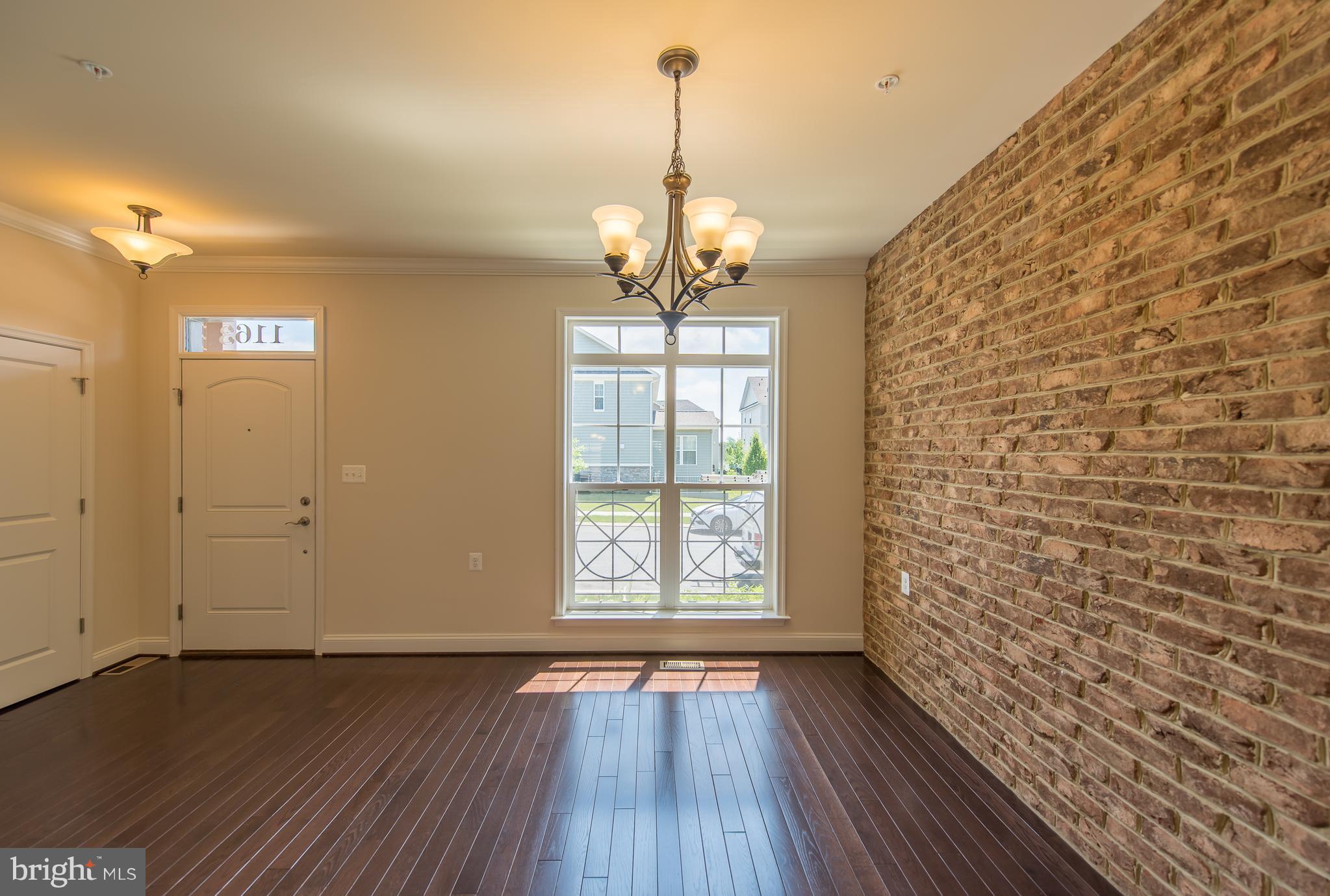 1163 Holden Road Frederick, MD 21701 - Photo 12 of 30 a view of a room with wooden floor chandeliers and kitchen view