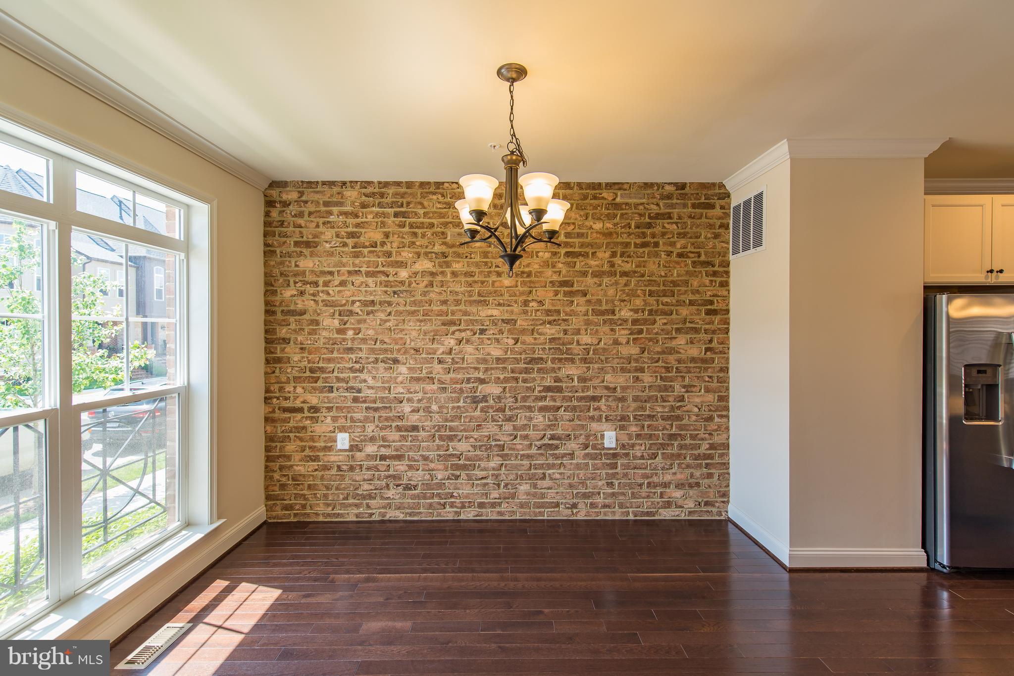 1163 Holden Road Frederick, MD 21701 - Photo 13 of 30 a view of empty room with wooden floor and window