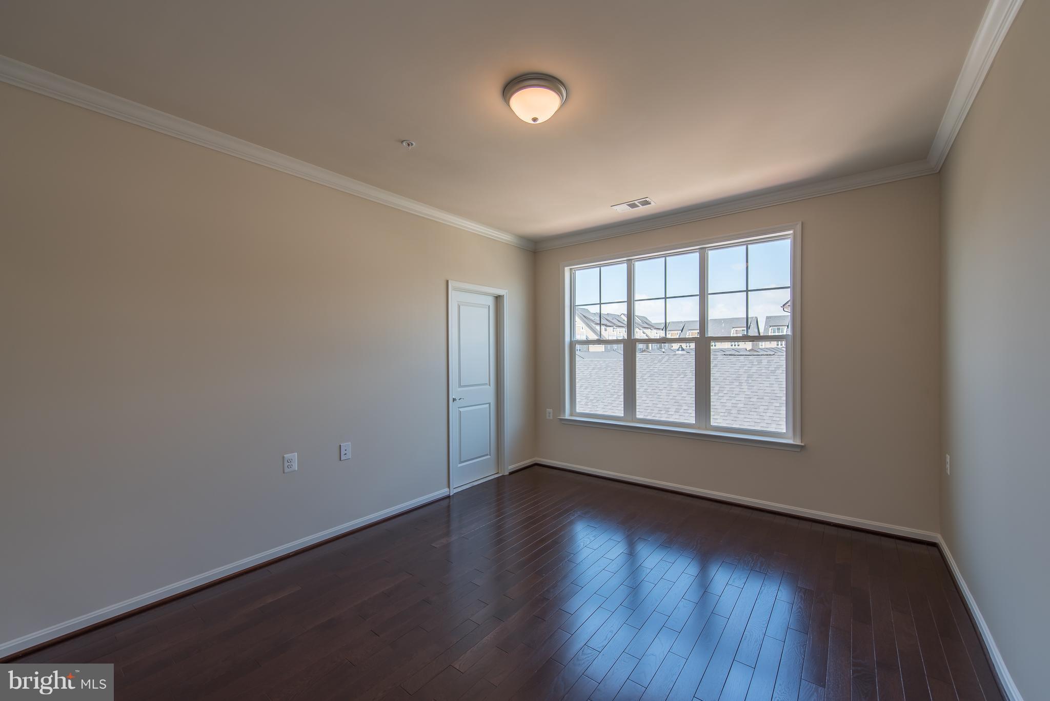 1163 Holden Road Frederick, MD 21701 - Photo 15 of 30 an empty room with wooden floor and windows