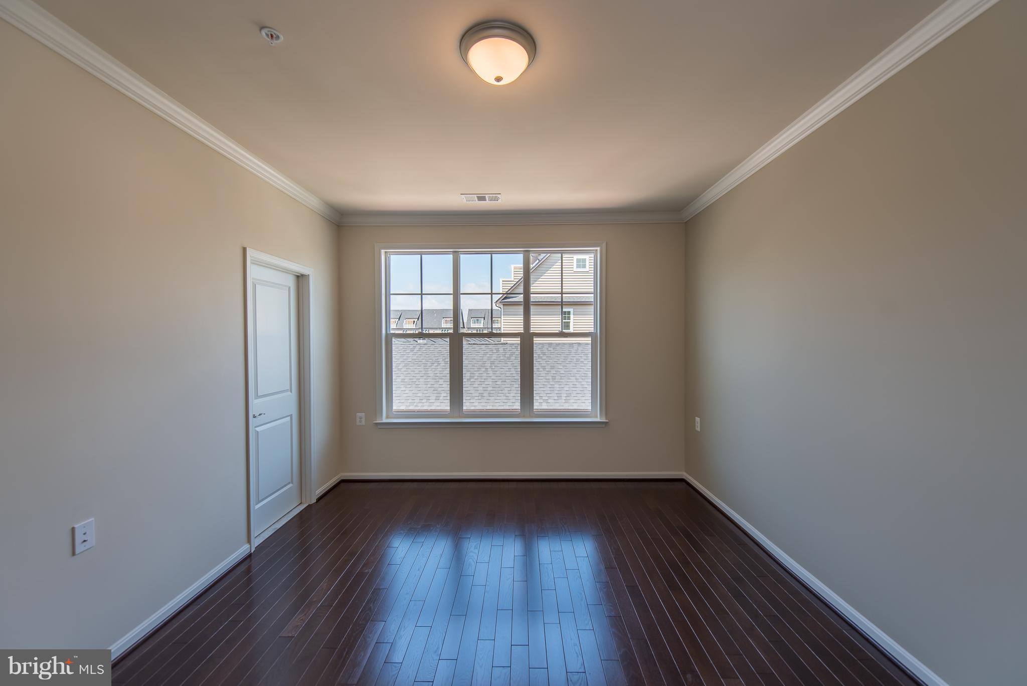 1163 Holden Road Frederick, MD 21701 - Photo 16 of 30 an empty room with wooden floor and windows