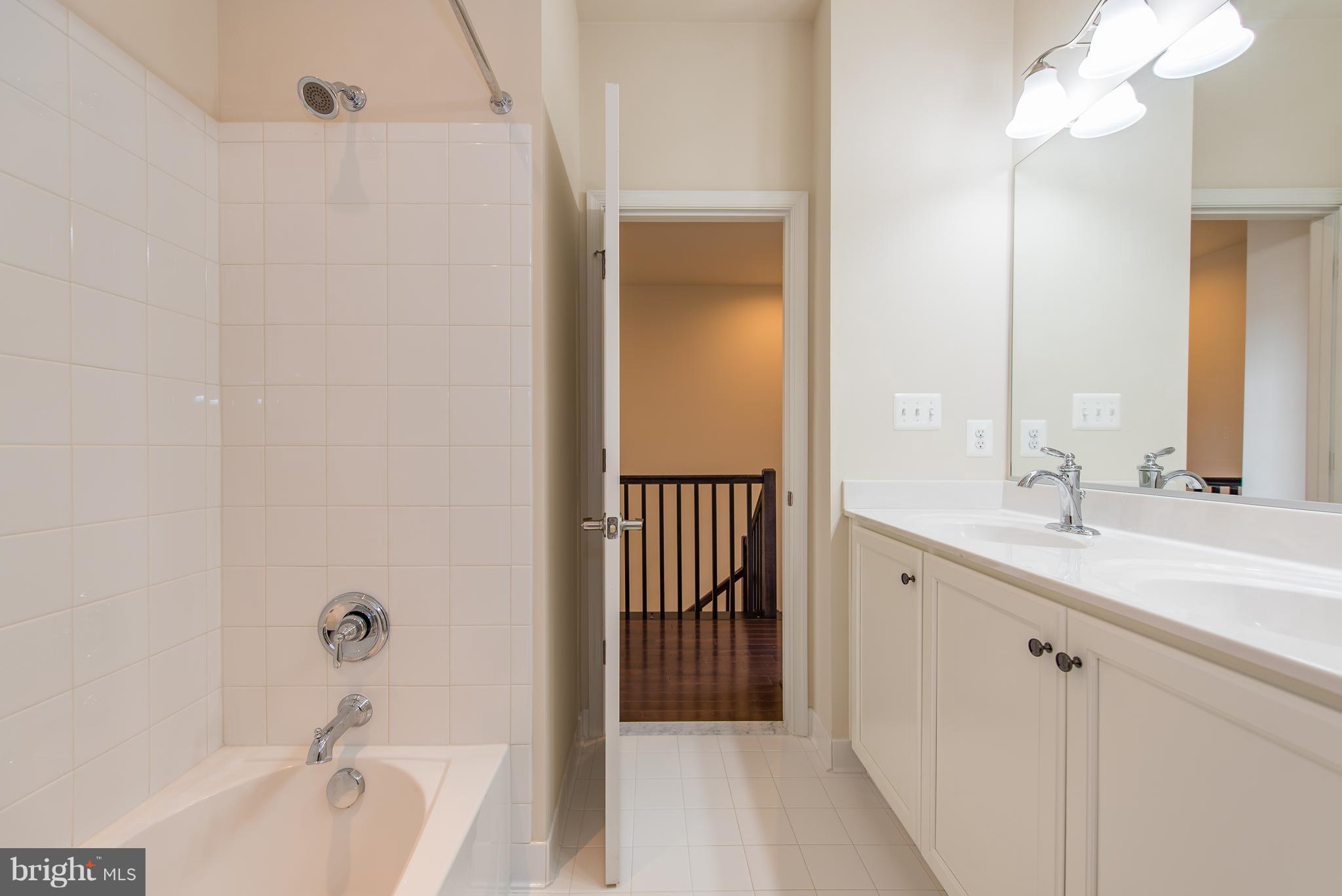 1163 Holden Road Frederick, MD 21701 - Photo 24 of 30 a bathroom with a tub sink and mirror