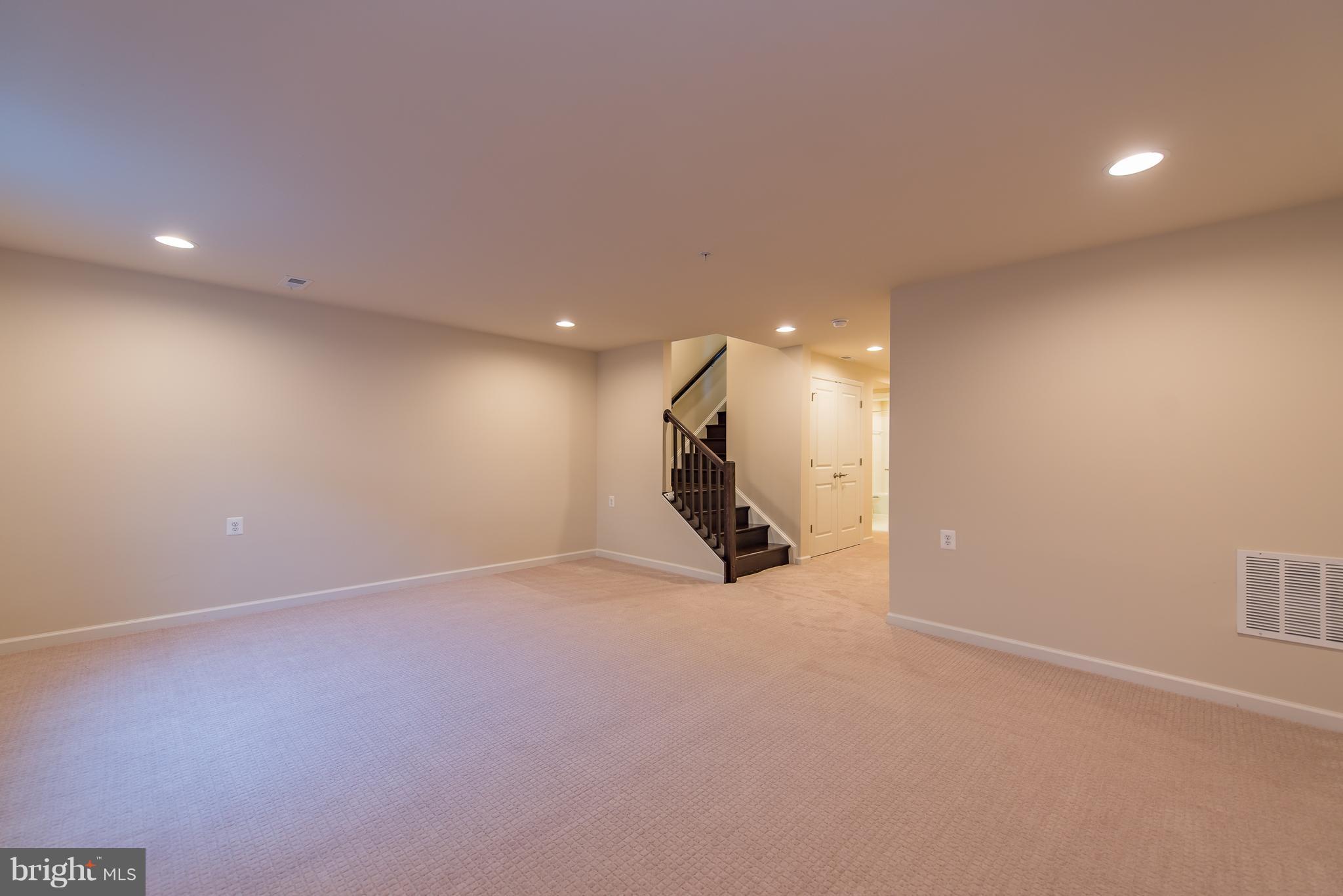 1163 Holden Road Frederick, MD 21701 - Photo 25 of 30 an empty room with a projector and windows