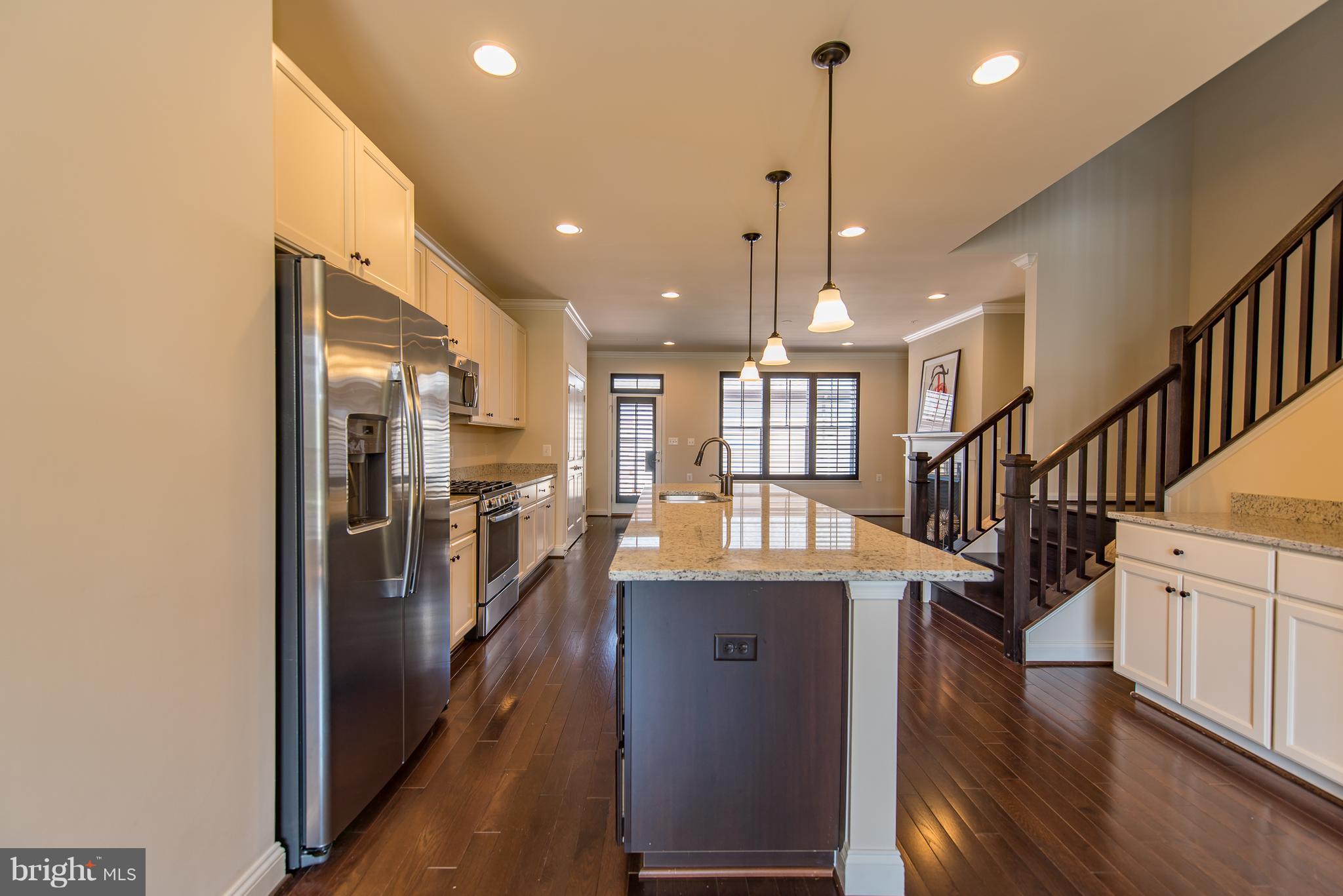 1163 Holden Road Frederick, MD 21701 - Photo 6 of 30 a view of a kitchen with refrigerator and wooden floor