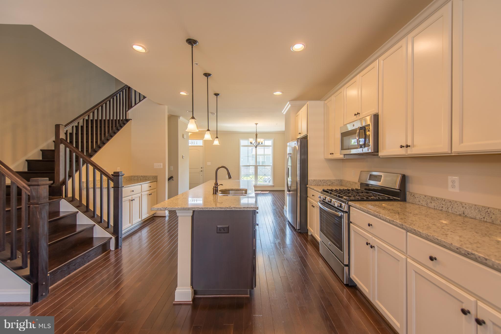 1163 Holden Road Frederick, MD 21701 - Photo 7 of 30 a kitchen with stainless steel appliances granite countertop a sink a stove and a wooden floors