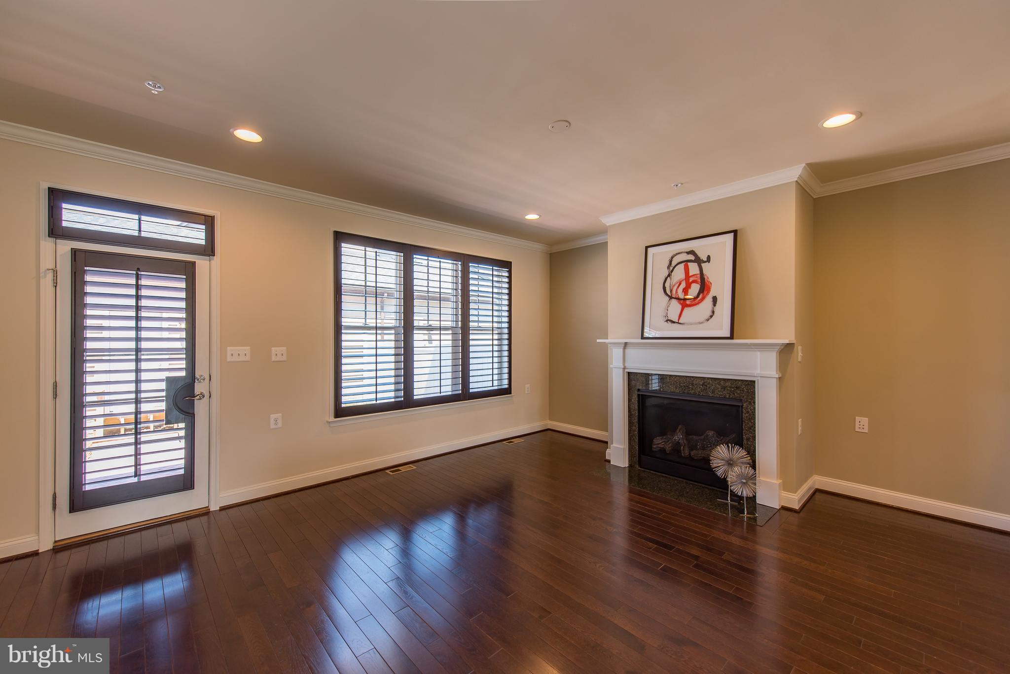 1163 Holden Road Frederick, MD 21701 - Photo 10 of 30 a view of an empty room with wooden floor and a window