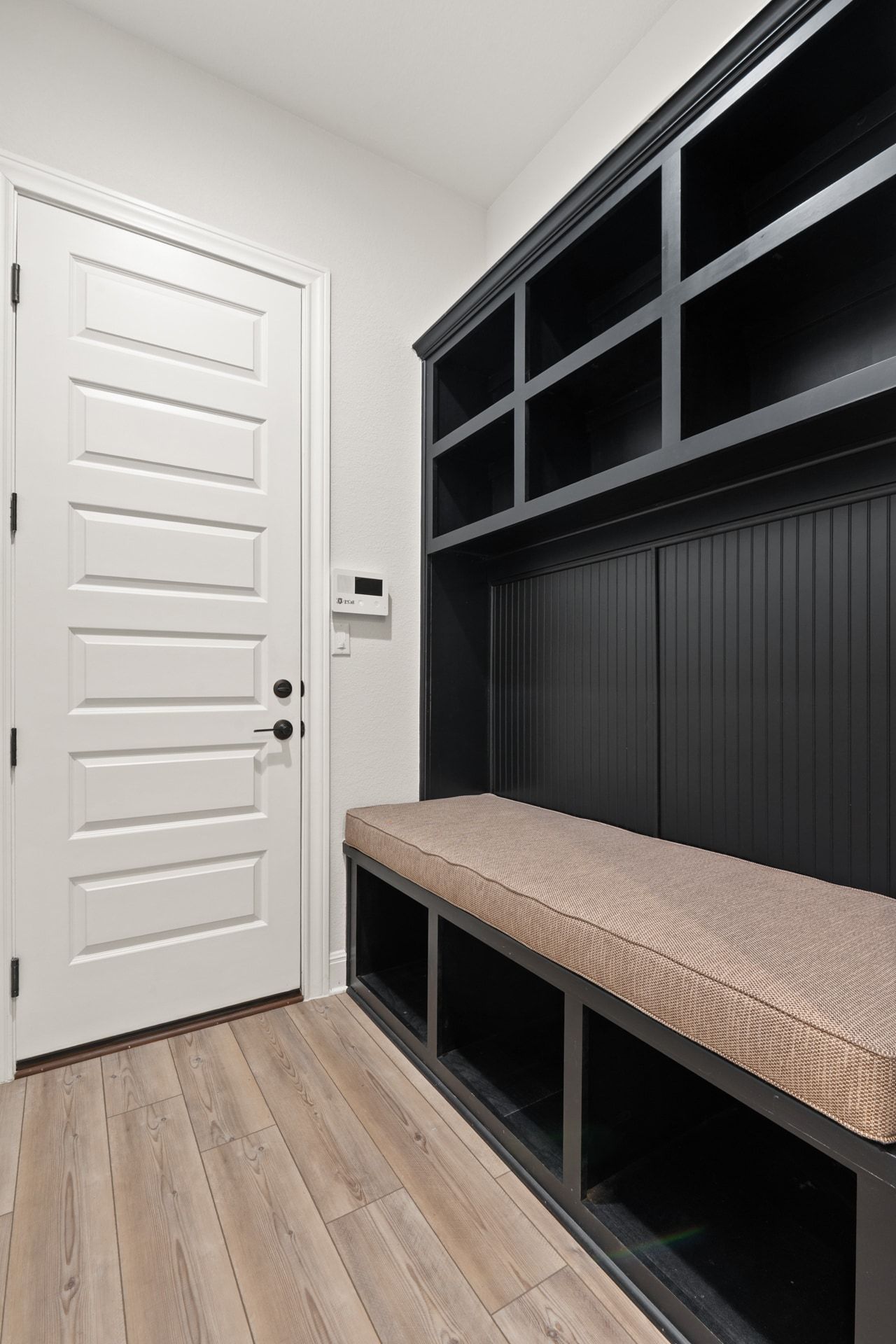 5420 Destination Way Jonestown, TX 78645 - Photo 22 of 39 A functional and stylish drop zone just off the garage offers custom built-ins with bench seating, open storage cubbies, and ample space to keep daily essentials organized.