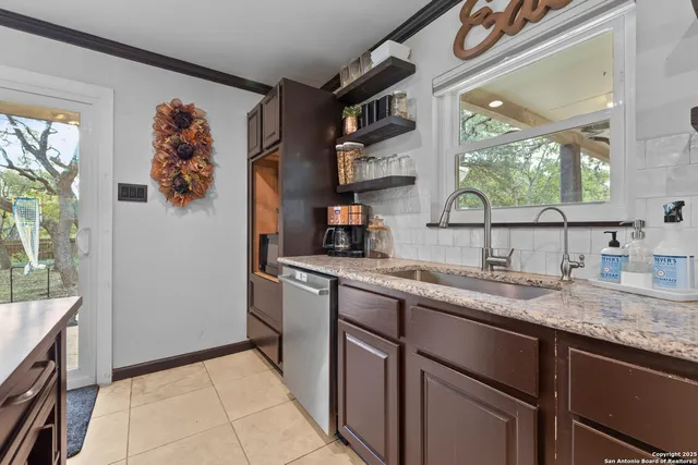 a kitchen with a sink cabinets and a window