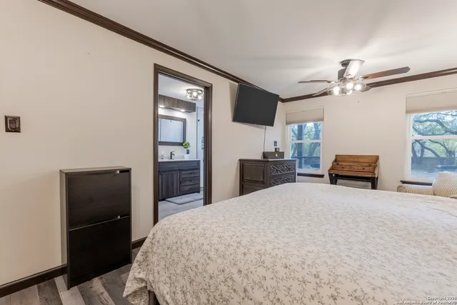 a large bedroom with a bed and a chandelier