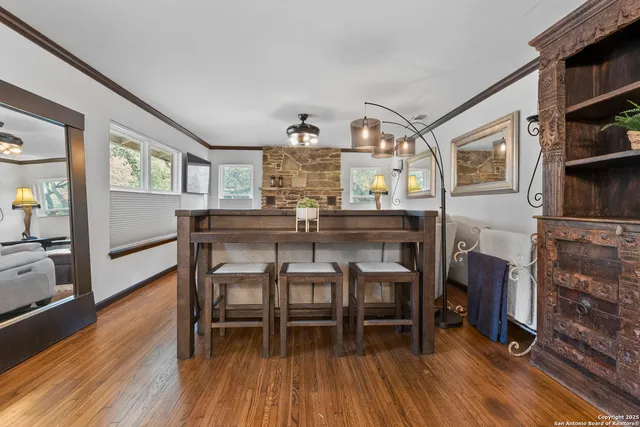 a dining room with furniture and wooden floor