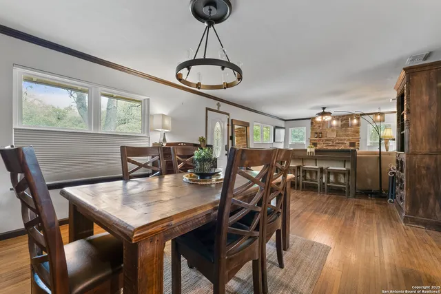 a view of a dining room with furniture window and wooden floor