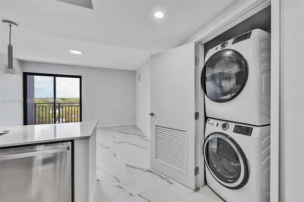 a view of a hallway with washer and dryer