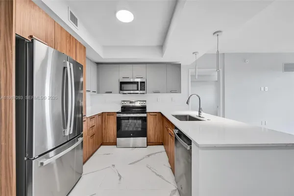 a kitchen with stainless steel appliances granite countertop a refrigerator a sink a stove a microwave and island