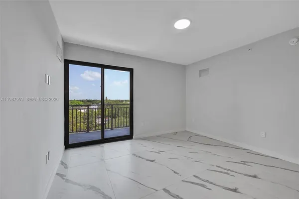 an empty room with entrance and windows
