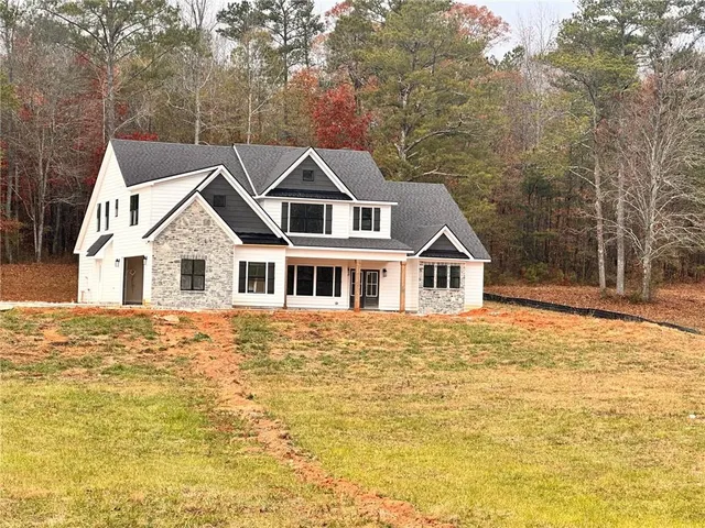 a house that has a tree in front of it