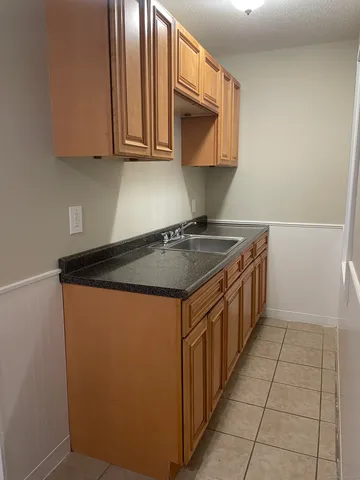 a kitchen with stainless steel appliances granite countertop a sink stove and microwave