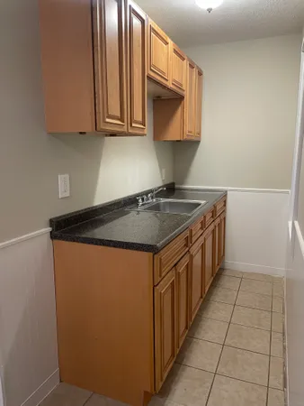 a kitchen with stainless steel appliances granite countertop a sink stove and microwave