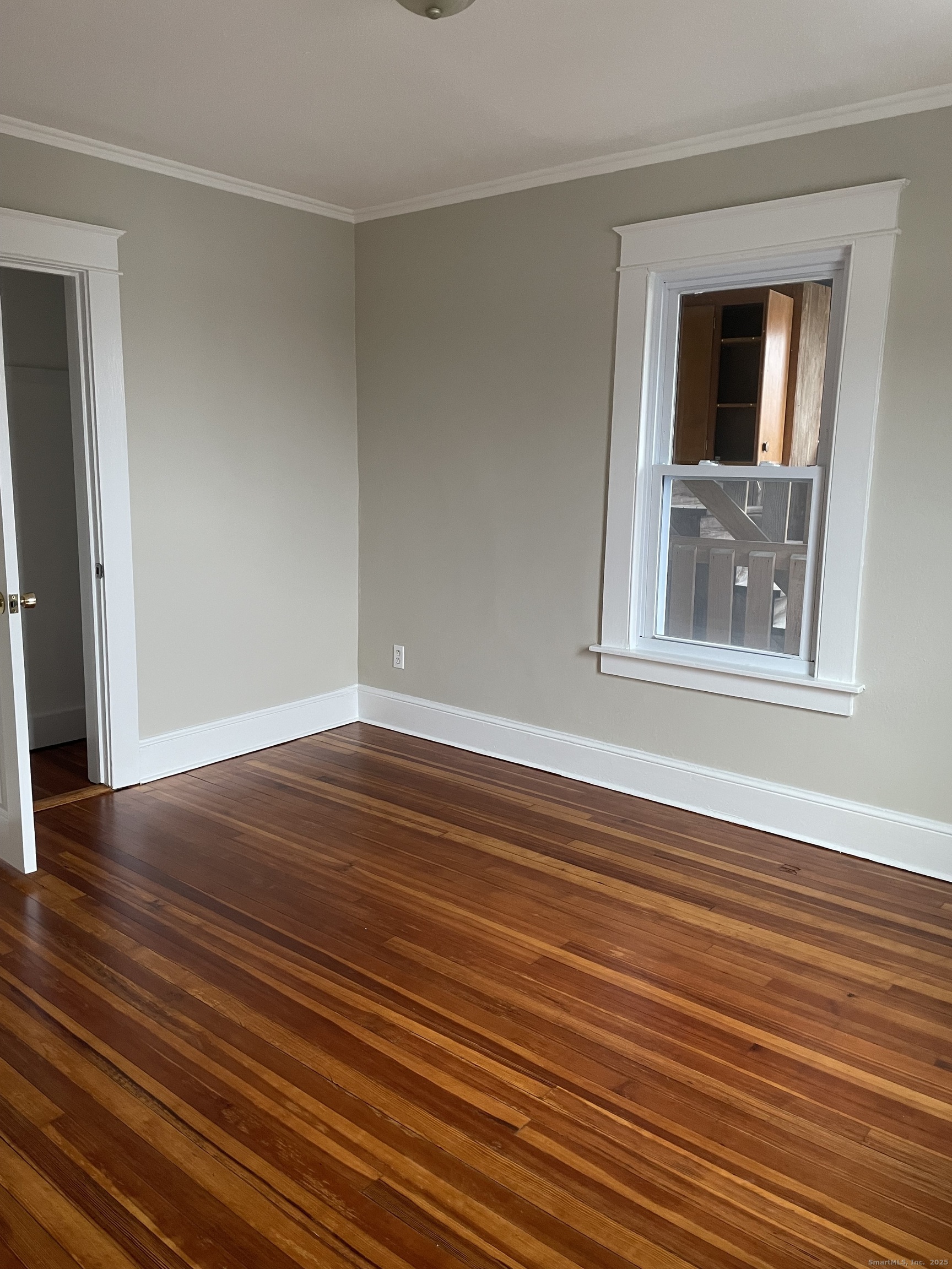 132 Gridley Street Bristol, CT 06010 - Photo 8 of 8 a view of empty room with wooden floor and fan