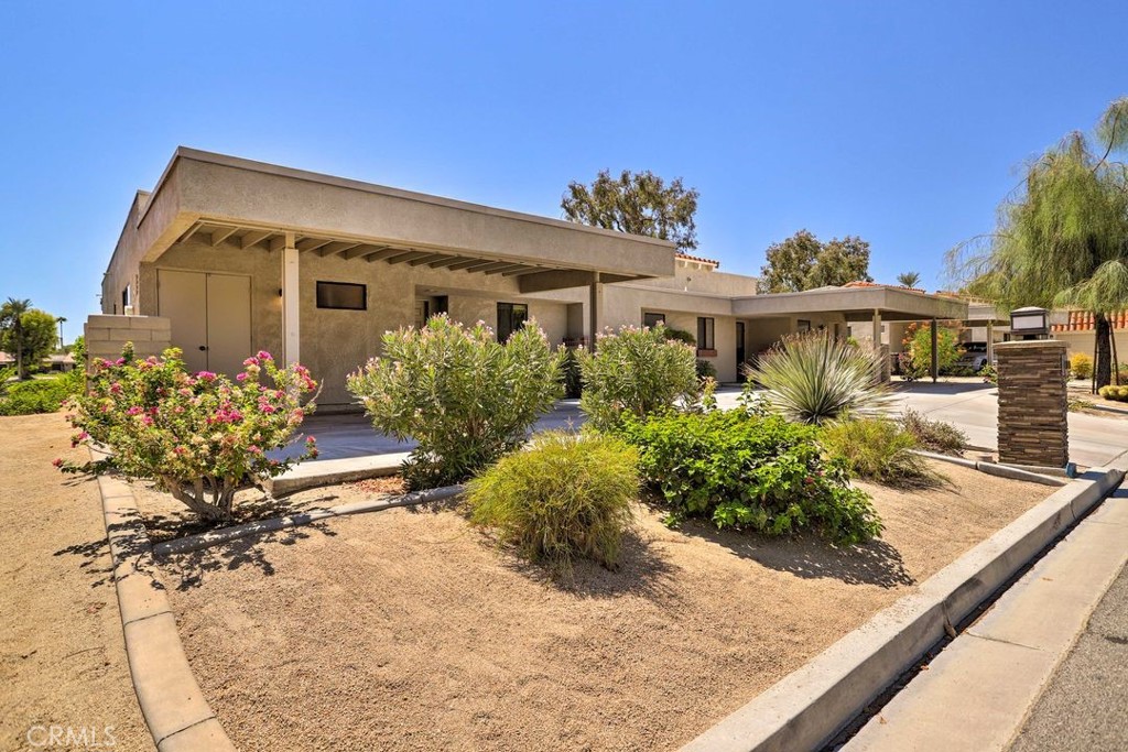 77313 Preston Trail Palm Desert, CA 92211 - Photo 2 of 15 a front view of a house with a yard