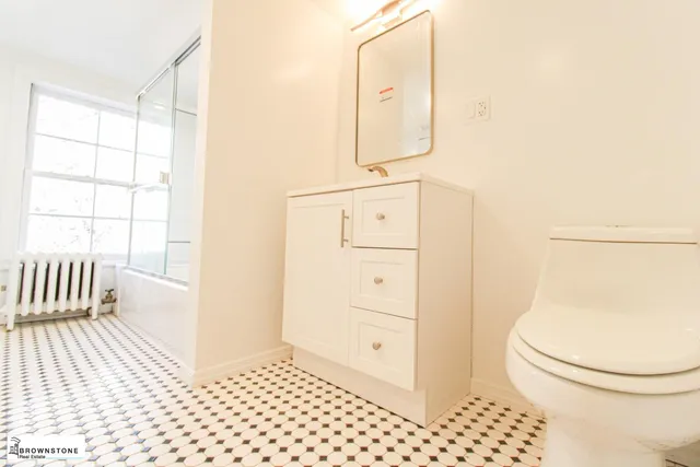 a bathroom with a sink a toilet and a mirror