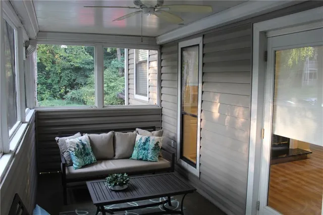 a view of a balcony with furniture and a ceiling fan