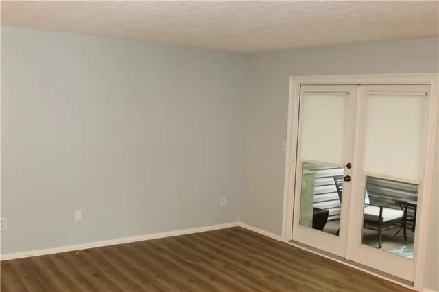 a view of a room with wooden floor and a ceiling fan
