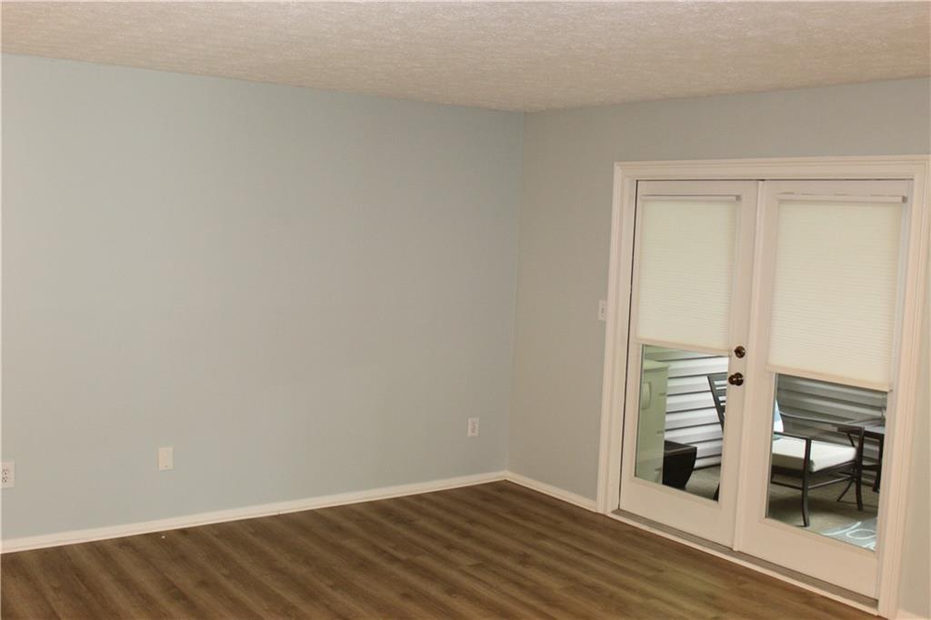 1508 Wynnes Ridge Circle Marietta, GA 30067 - Photo 7 of 15 a view of a room with wooden floor and a ceiling fan