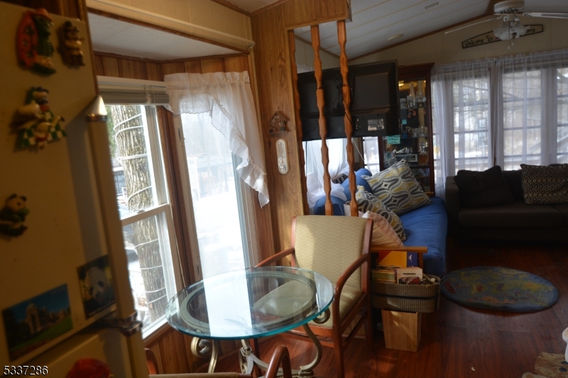 42 Elm Village Vernon, NJ 07461 - Photo 11 of 33 a living room with furniture and a floor to ceiling window
