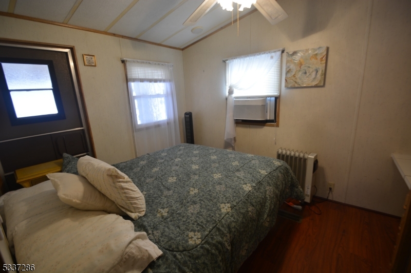 42 Elm Village Vernon, NJ 07461 - Photo 14 of 33 a bedroom with a bed and wooden floor