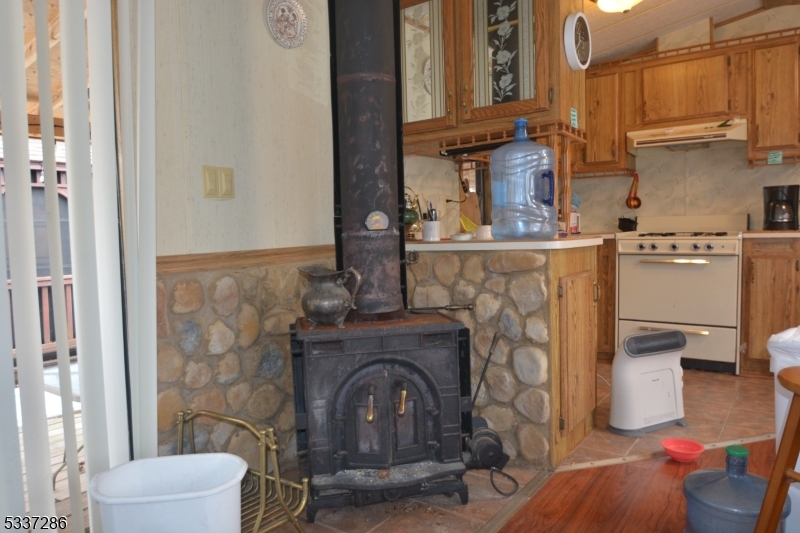 42 Elm Village Vernon, NJ 07461 - Photo 2 of 33 a living room with furniture a fireplace and a chandelier