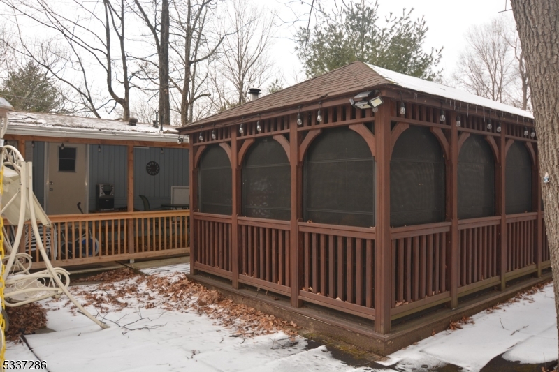 42 Elm Village Vernon, NJ 07461 - Photo 22 of 33 a view of a wooden house with a deck