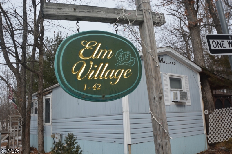42 Elm Village Vernon, NJ 07461 - Photo 4 of 33 a sign that is on a wooden wall
