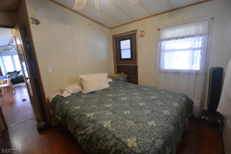 42 Elm Village Vernon, NJ 07461 - Photo 8 of 33 a bed sitting in a bedroom next to a window