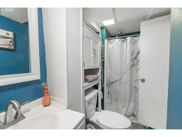a bathroom with a sink toilet and shower